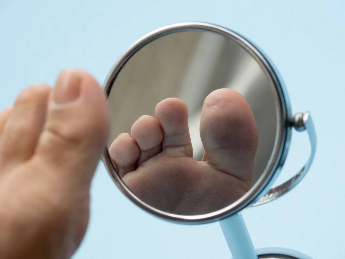 A handy tip is to use a mirror to look more closely at your toes! A mirror makes it easier to see in between your toes when it's not so easy for you to bend down and inspect them.