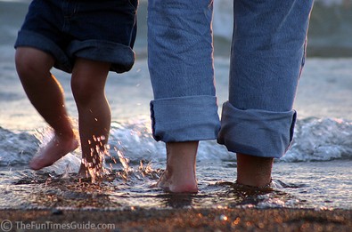 Summertime feet splashing in the water.