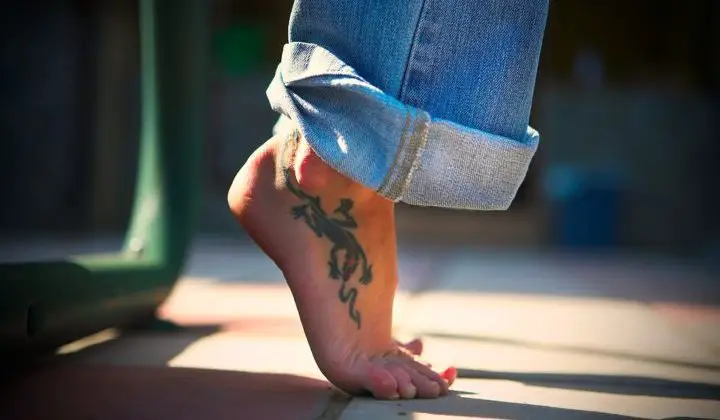 A large lizard foot tattoo.
