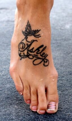 Large foot tattoos tend to be very detailed. See why large tattoos are not recommended on your feet. This one is a name tattooed on top of the foot.